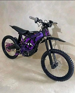 SUR-RON Light Bee X electric bike. Key features and information include:  Type: Electric off-road bike Top Speed: Up to 47 mph Range: Around 60 miles on a full charge, but can vary based on riding conditions Charge Time: Approximately 2.5 hours Battery: 60V, with some models offering up to 40Ah Motor: 6kW peak power Weight: 47 kg (103 lbs) Legality: Primarily designed for off-road use; street legality varies by location Manufacturing: Built in China Features: LCD dash display, sport mode, LED headlight, hydraulic disc brakes