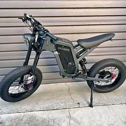 Surron Light Bee X, an electric dirt bike. Key features include:  Type: Electric, blending dirt bike and mountain bike elements.  Speed: Can reach speeds of 45-50 mph after unlocking the speed limiter.  Battery: Powered by a removable 60-volt Panasonic lithium-ion battery.  Range: Offers a range of 20-60 miles per charge, varying with riding mode and intensity.  Display: Features an LCD display showing speed, battery level, and travel distance.  Safety: Equipped with LED headlight and rear brake warning light for night riding.  Weight: Net weight is 47kg plus the battery.  Road Legal: In some regions, it's road legal as an electric moped, requiring license, registration, and insurance.