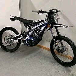 Sur-Ron Light Bee X, an electric dirt bike. Key features include:  Type: Electric dirt bike, blending elements of a mountain bike and a motorcycle.  Speed: Top speed of 45-50 mph after unlocking the speed limiter.  Range: Approximately 40-60 miles on a full charge, depending on riding conditions.  Age Restrictions: Riders should be at least 16 years old, but local regulations may vary.  Street Legal: Generally not street legal and primarily designed for off-road use.  Modifications: Customizable with options like custom graphics and anodized parts.  Alternatives: Other similar models include the Rawrr Mantis X and E Ride Pro SS 3.0.