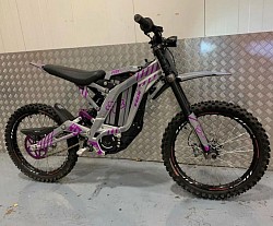 Surron Light Bee X electric dirt bike. Helpful information includes:  It has a top speed of 47 mph. The range is approximately 40-60 miles on a full charge. It weighs 47 kg without the battery. Features regenerative braking. Some models have a reverse mode and traction control. It can be made street legal with the addition of mirrors and registration, depending on local laws.