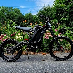 2024 SURRON Light Bee X Electric Bike. Key features include:  Type: Electric dirt bike. Use: Suitable for various terrains, including trails, enduro, and freestyle riding. Range: Approximately 40-80 miles on a single charge, depending on conditions. Top Speed: Up to 47 mph (73 km/h), varying with load and gearing. Weight: Around 47 kg plus the battery. Motor: Liquid-cooled, brushless electric motor. Tires: 19-inch spoke wheels with CST tires. Battery: 104V/55Ah Lithium-Ion.
