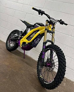 Surron Light Bee X electric bike. Key features include:  It is an electric dirt bike, blending aspects of a mountain bike and a dirt bike.  The bike has a range of 40-80 miles on a single charge.  It can reach a top speed of 47 mph, depending on load and gearing.  The Surron Light Bee X weighs approximately 47 kg without the battery.  It features 19-inch spoke wheels and CST tires.  Some models have upgraded components, such as custom graphics and anodized parts.  The Surron is designed to handle challenging off-road terrain.