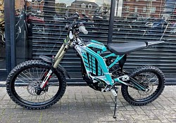 Surron Light Bee X electric dirt bike. Key features include:  Type: Electric dirt bike Top Speed: Up to 45 mph Range: 40 to 60 miles, may vary based on conditions Weight: Around 104 lbs Battery: 60V Street Legal: Can be made street legal with proper modifications and registration, depending on local laws Motor: 8 kW New 2024 models: may feature upgraded motors and 18-inch rear wheels