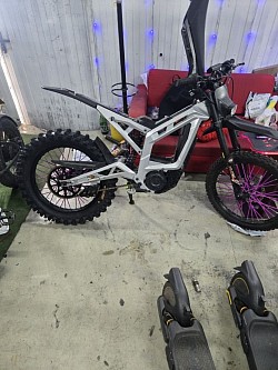 SURRON Light Bee X Electric Bike. Helpful information includes:  It is an electric dirt bike designed primarily for off-road use.  It can reach speeds up to 47 mph, depending on load and gearing.  The bike's battery can provide a range of 40-80 miles on a single charge.  It has a net weight of 47 kg, excluding the battery.  In some regions, this bike may not be street-legal and could be categorized differently from standard e-bikes due to its speed and lack of pedals.