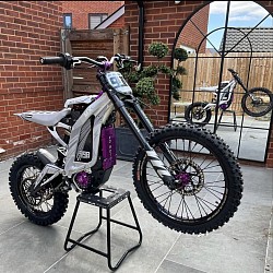 2024 SURRON Light Bee X Electric Bike. This electric dirt bike is designed for off-road use but can be modified for street legality.  Key features include:  Top speed: 45 mph+. Range: 20 to 60 miles per charge, depending on the mode. Recharge time: 2.5 to 3.5 hours. Maximum load weight: 250 lbs. Climbing ability: Over 45 degrees. Battery: 60V 32A. Power: 7000W peak.