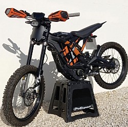 SURRON Light Bee X Electric Bike. Key features include:  It is an electric dirt bike, blending aspects of a dirt bike and a mountain bike.  The bike has a top speed of around 47 mph (73 km/h).  The range is approximately 40-60 miles on a single charge, but can extend up to 80 miles depending on conditions.  It uses a 60V 38ah battery with Samsung cells.  The bike weighs 47 kg without the battery.  Features KKE suspension and twin-pot hydraulic brakes.  It is equipped with a 6000W peak power motor.  The wheels are 19-inch spoke wheels with CST off-road tires.